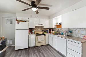 Unit 4 Kitchen with light countertops, white appliances, white cabinetry, and light wood finished floors