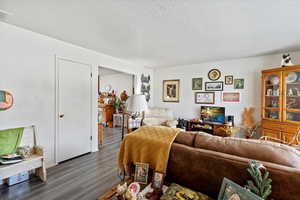 Unit 2 Living area featuring a textured ceiling and wood finished floors
