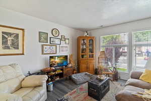Unit 2 Living room with a textured ceiling and wood finished floors