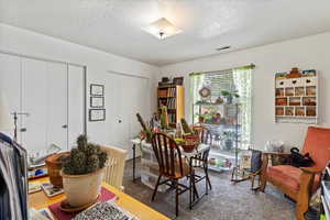 Unit 2 Bedroom with a textured ceiling and carpet