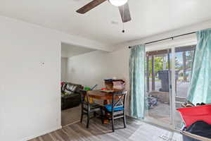 Unit 4 Dining space with wood finished floors and ceiling fan