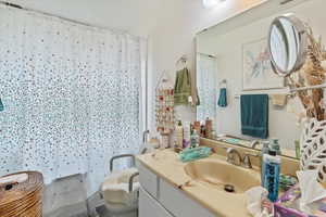 Unit 2 Full bathroom featuring vanity and shower / bathtub combination with curtain