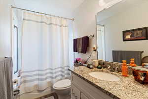 Unit 3 Bathroom featuring vanity and shower / bathtub combination with curtain