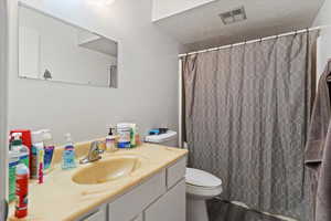 Unit 4 Full bathroom with a textured ceiling, vanity, dark wood-style flooring, and a shower with shower curtain