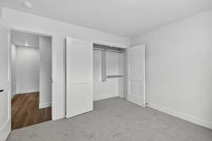 Unfurnished bedroom featuring carpet and a closet