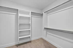 Spacious closet with light colored carpet