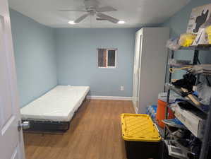 Bedroom featuring wood finished floors and a ceiling fan