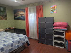 Bedroom featuring dark wood-type flooring
