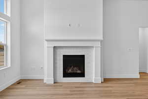 Detailed view of a fireplace and wood finished floors