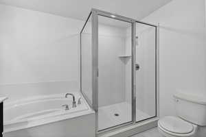Bathroom featuring a garden tub, a stall shower, and vanity