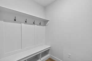 Mudroom featuring baseboards and wood finished floors
