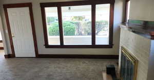 Unfurnished living room with carpet flooring and a fireplace