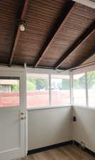 Unfurnished sunroom with wood finished floors