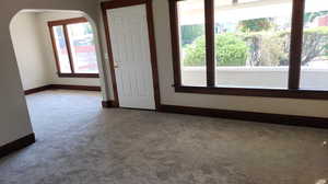 Spare room featuring carpet floors and arched walkways