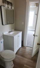 Bathroom featuring vanity, dark wood-style flooring, and ceiling fan