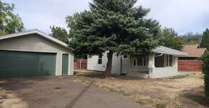 View of front of home with an outbuilding and a garage