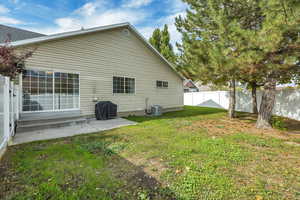Rear view of property featuring a patio, entry steps, and a fenced backyard