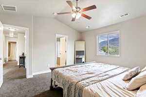 Master Bedroom with carpet flooring, vaulted ceiling, connected bathroom, ceiling fan, and a mountain view