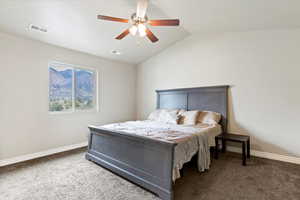 Master Carpeted bedroom with vaulted ceiling and a ceiling fan