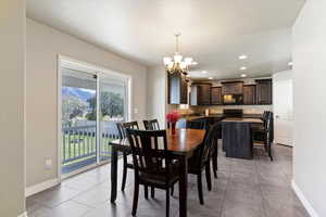 Dining room featuring recessed lighting, a chandelier, and light tile patterned floors