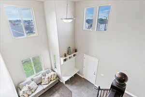 Foyer featuring a towering ceiling and baseboards
