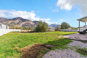 Fenced backyard with a mountain view