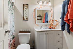 Bathroom with vanity and curtained shower