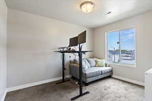 Carpeted bedroom with baseboards