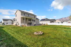 Back of house with an outdoor fire pit, a patio, a residential view, and stucco siding