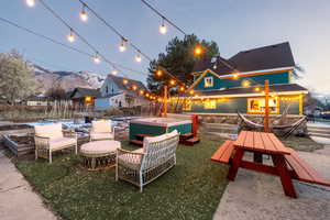 View of patio featuring a jacuzzi, a mountain view, and outdoor dining area