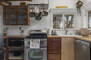 Kitchen with stainless steel appliances and wooden counters
