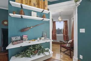 Interior space featuring wood finished floors and ornamental molding