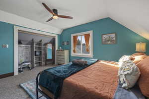 Bedroom with carpet floors, vaulted ceiling, and a ceiling fan