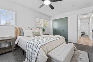 Carpeted bedroom featuring a closet and a ceiling fan