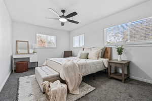 Bedroom with carpet, ceiling fan, and a desk