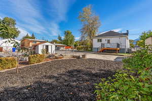 Fenced backyard featuring an outbuilding and a gate