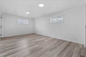 Spare room with healthy amount of natural light and light wood-type flooring