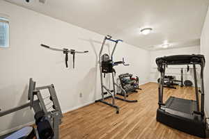 Exercise area featuring light wood-type flooring and baseboards