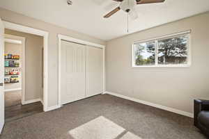 Unfurnished bedroom with carpet floors, a closet, and ceiling fan