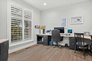 Home office featuring light wood finished floors and recessed lighting