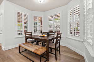 Dining room featuring light wood finished floors and baseboards