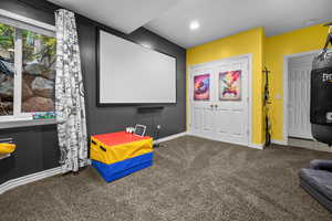 Carpeted home theater with baseboards and recessed lighting