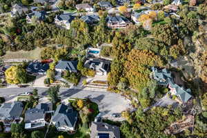 Aerial view of property and surrounding area with nearby suburban area