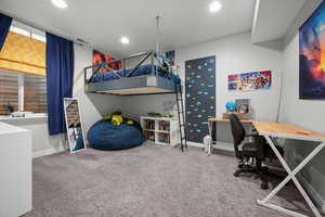 Bedroom featuring a desk, light colored carpet, and recessed lighting