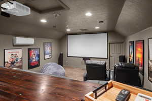 Home theater with lofted ceiling, a textured ceiling, carpet, and recessed lighting
