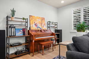 Sitting room with light wood-type flooring and recessed lighting