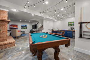 Rec room with bar with sink, billiards, and beverage cooler