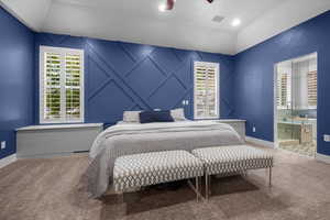 Bedroom featuring carpet, a ceiling fan, and vaulted ceiling