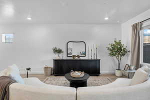 Living room featuring healthy amount of natural light, wood finished floors, and recessed lighting