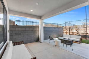 Fenced backyard with an outdoor hangout area and a patio